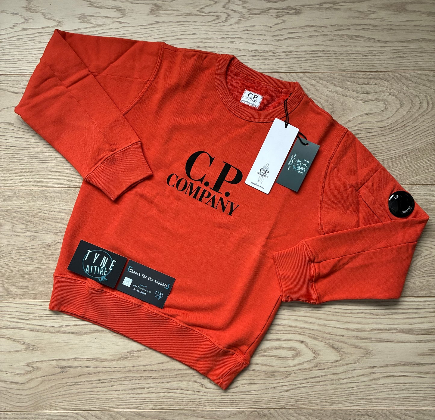 C.P. Company Junior Spellout Logo Arm Pocket Lens Pumpkin Orange Crewneck Sweater